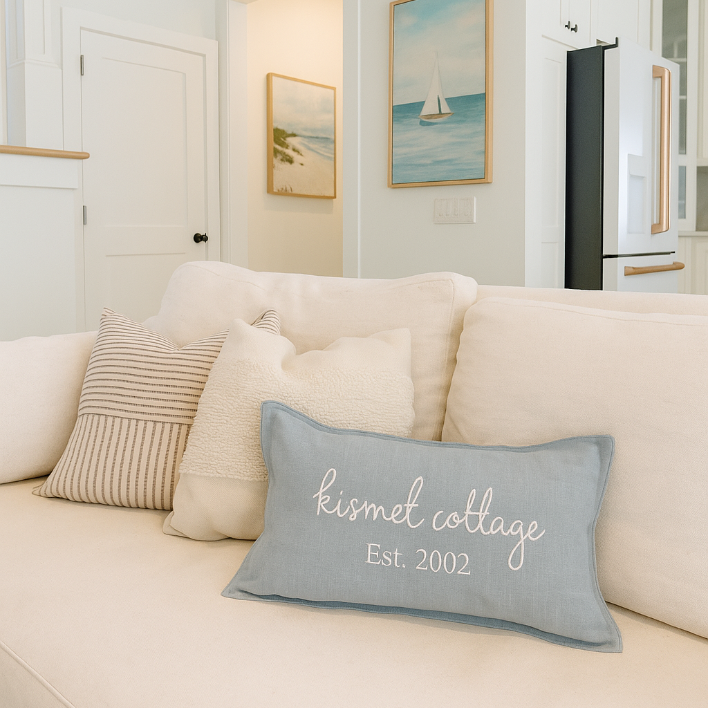 Embroidered Pillow Cover with 'Kismet Cottage Est. 2002' text in a beach house along 30A.