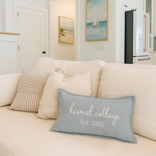 Embroidered Pillow Cover with 'Kismet Cottage Est. 2002' text in a beach house along 30A.